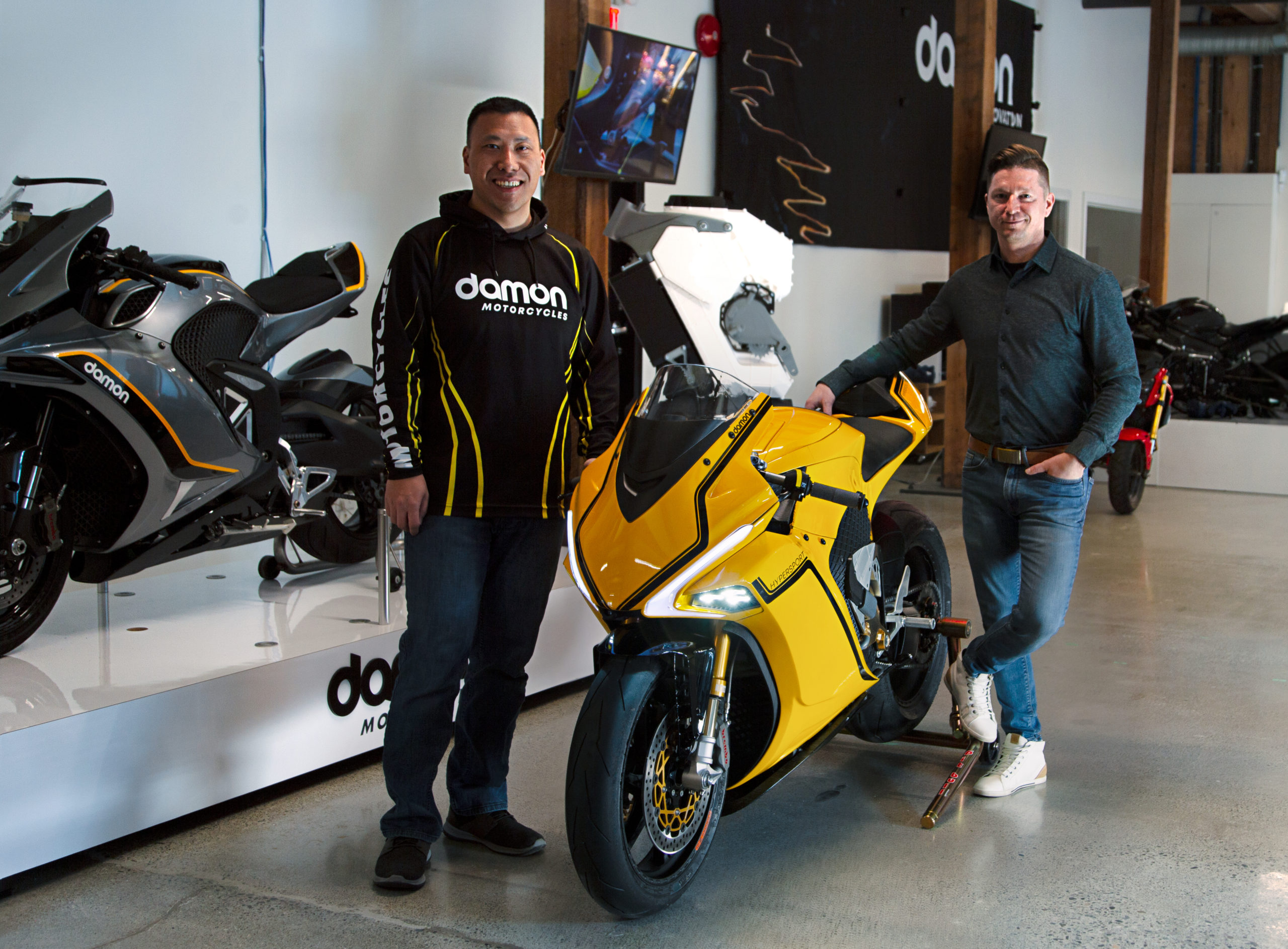 CEO Jay Jiraud with his hand on the Damon HyperSport motorcycle