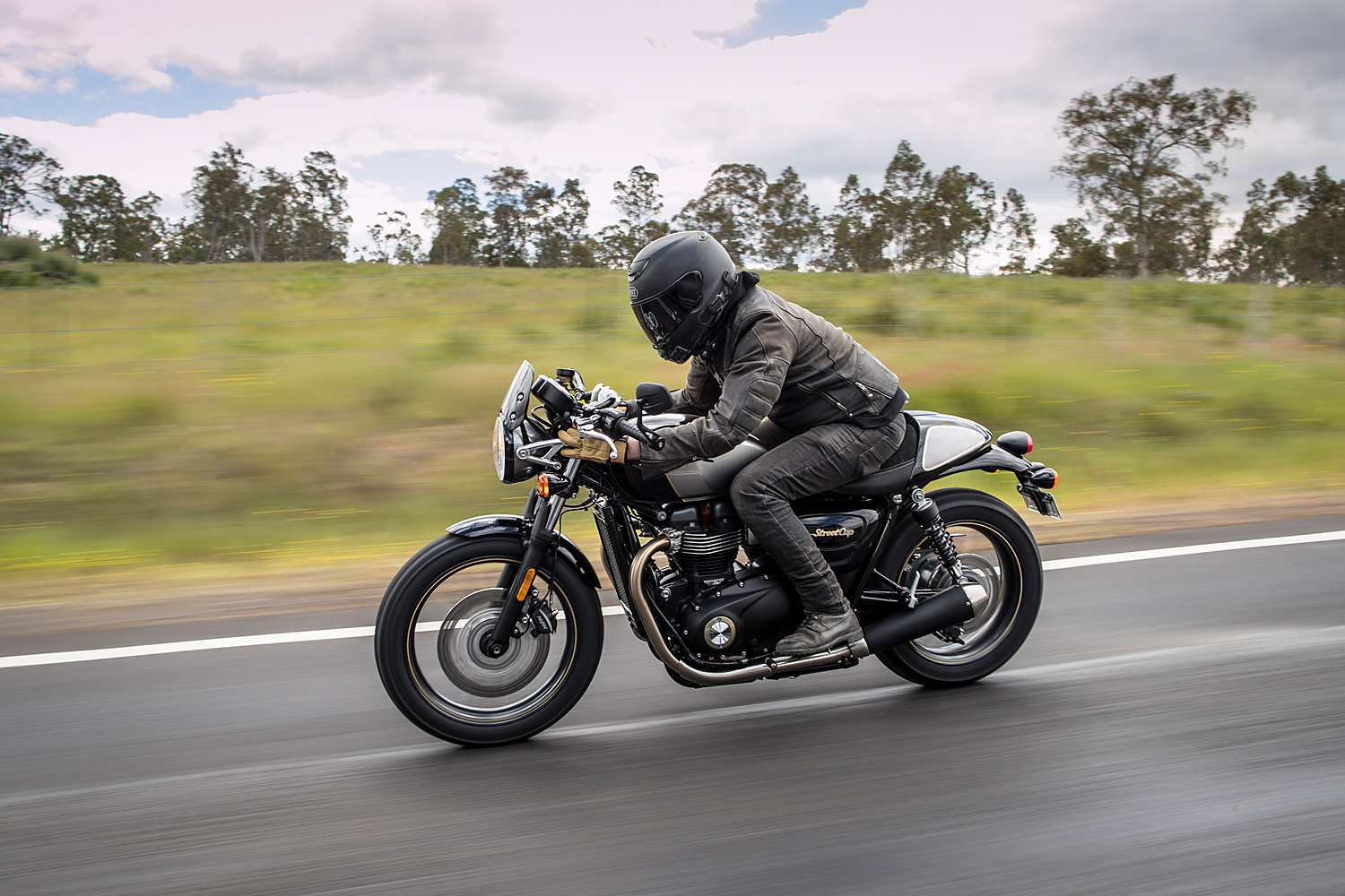 A Thruxton Bonneville Street Cup motorcycle on a quiet road in tasmania