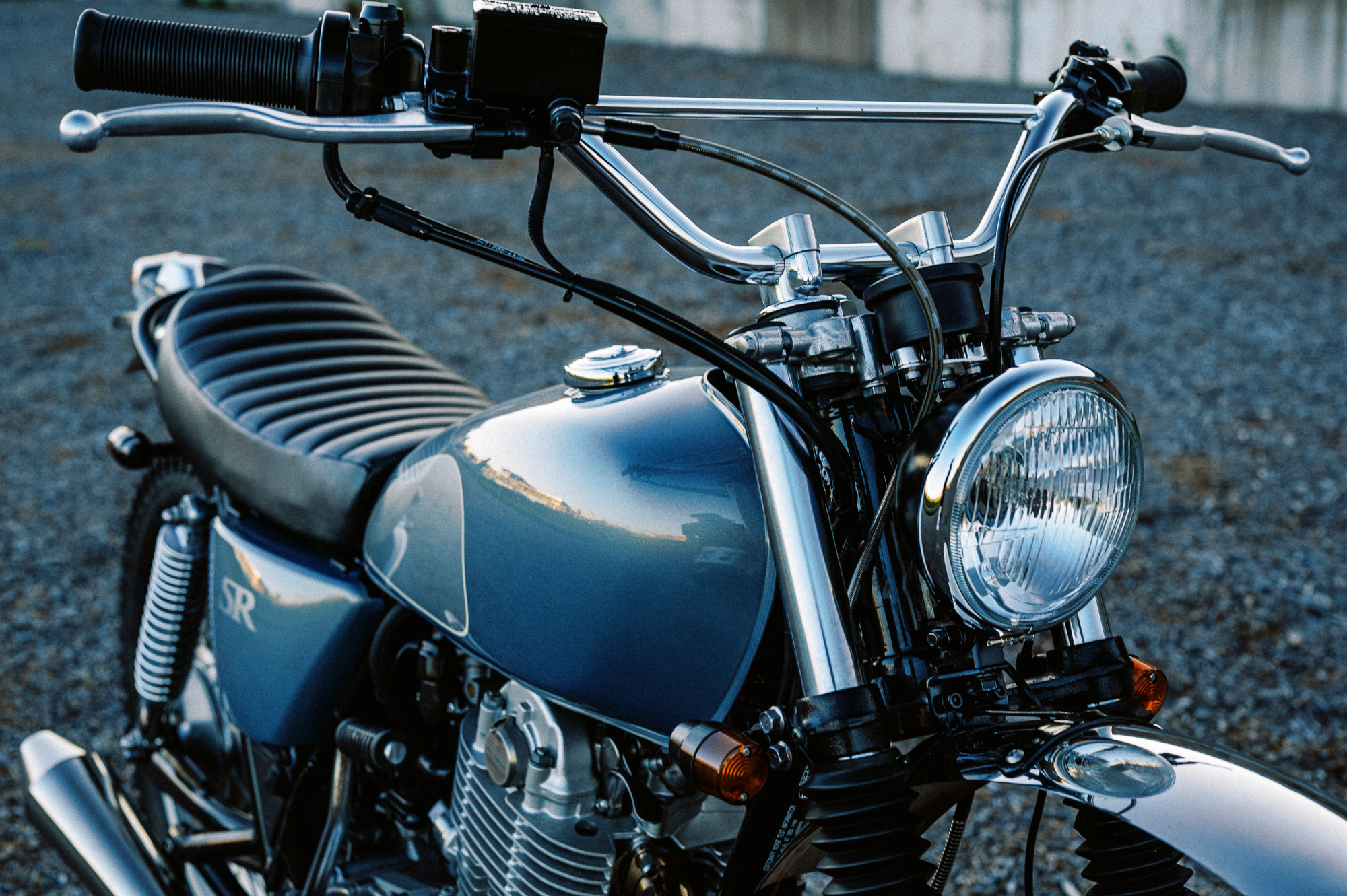 a custom Yamaha SR400 Motorcycle in Sydney at dusk in a vacant lot
