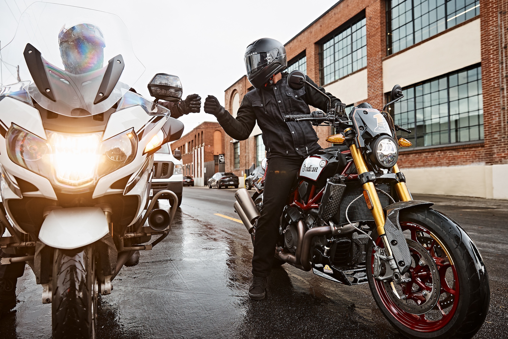 A fist-bumping motorcyclist.
