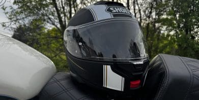 Shoei Neotec 3 Satori TC-5 Helmet resting on saddlemen seat of harley davidson sportster 883